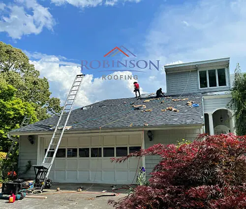 Homepage image Robinson Roofing Robinson Roofing Employee working on new shingle roof