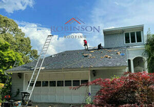 Robinson Roofing Employee working on new shingle roof in Midway NC